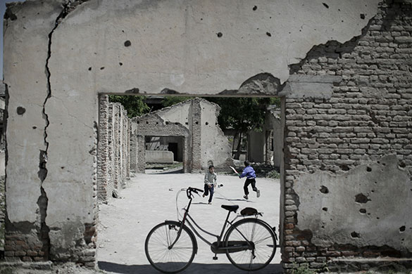 24 Hours in Pics: Afghan boys play cricket inside the ruins of a compound in Kabul