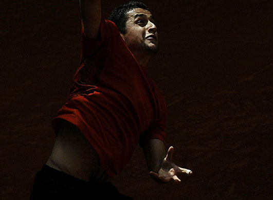 24 Hours in Pics: Spaniard Nicolas Almagro serves a ball during the Madrid Masters