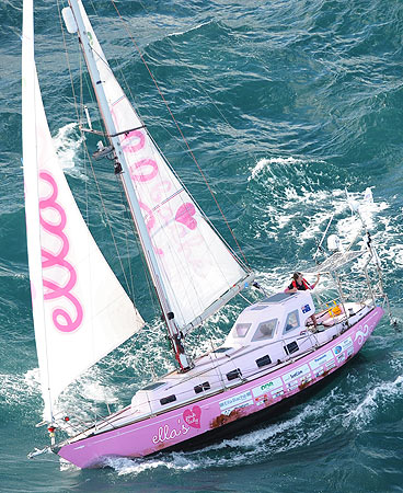 Jessica Watson waves as she sails into Sydney Harbour on board her yacht, Ella's Pink Lady