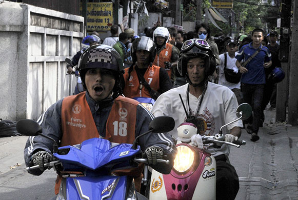 Bangkok Riots: Motorbike taxi drivers flee as Thai army soldiers open fire