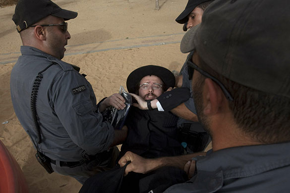 24 hours in pictures: Israeli police arrest Orthodox man protesting against the removal of tombs 