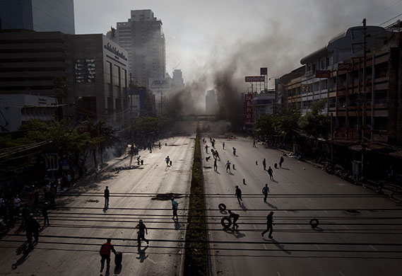 24 hours in pictures: Redshirts make a burning barricade in Bangkok