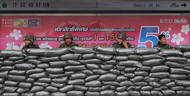 Thailand protests: Thai soldiers sits inside their bunker at a bus stop