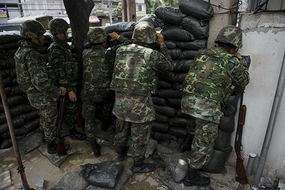 Thailand protests: Thai soldiers look out from their sand-bagged position in Bangkok