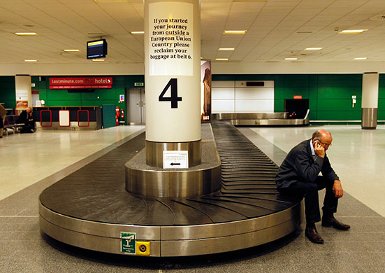 Volcanic ash: Man sits on an empty luggage conveyor belt Edinburgh