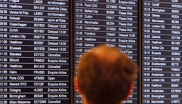 Volcanic ash: Man views an airline departures board Edinburgh airport
