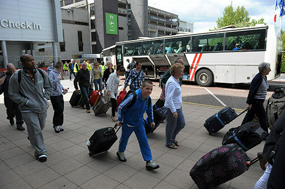 Volcanic ash: Passengers board buses at Manchester Airport, after the airport was closed