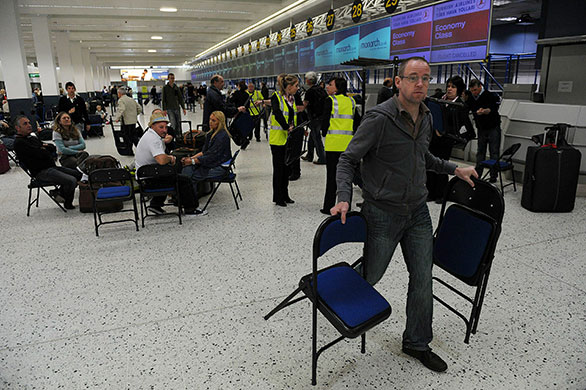 Volcanic ash: Staff hand out  chairs to passengers at Manchester Airport