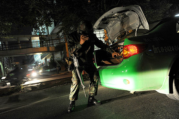 bangkok standoff: A soldier checks the trunk of taxi in bangkok