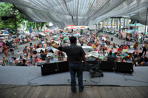 Thai clashes: A Red Shirt protest leader delivers a speech on stage 