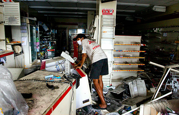 Thai clashes: A Thai walks through a ransacked convenience store