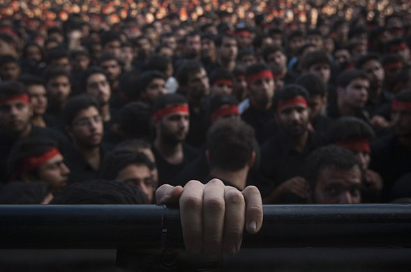 24 hours in pictures: Iranians take part in a religious ceremony in southern Tehran