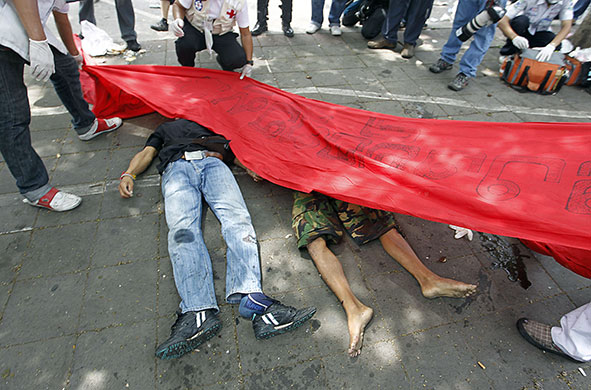 protests in Thailand: A red banner is lowered over the bodies of two protesters