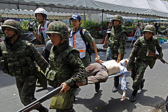 Bangkok protests: An injured journalist is carried to an ambulance