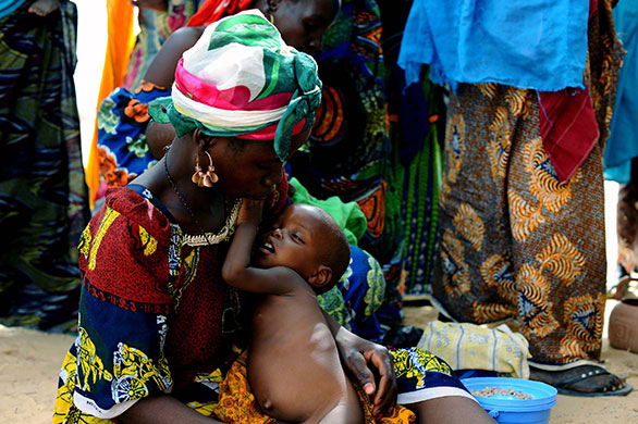 Niger Children: Saratou holding her son Badamassi, 18 months, as they wait to be weighed