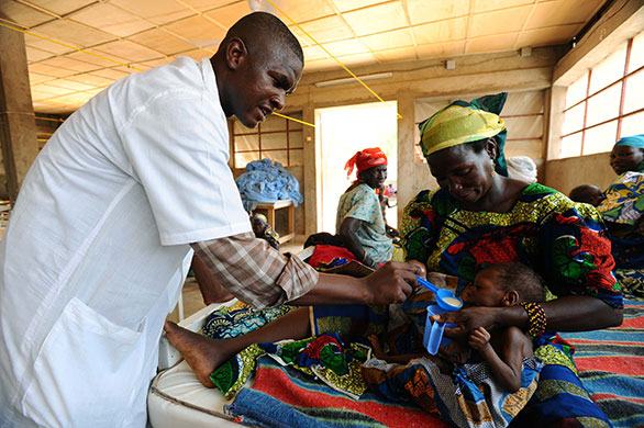 Niger Children: Nurse Ali helps Mariama feed her daughter Salaha therapeutic milk