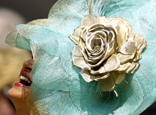 Epsom fashion: A woman laughs during Ladies Day at the Epsom Downs race course