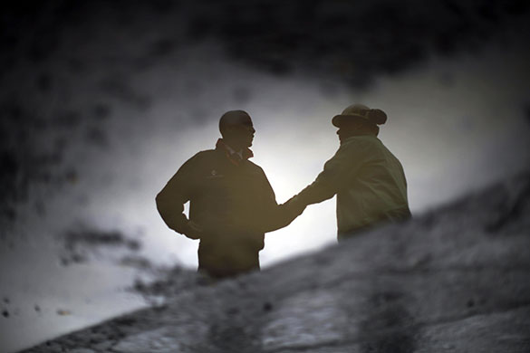 24 hours in pictures: Youngstown, US: Barack Obama is reflected in a puddle