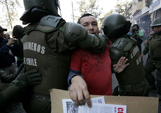May Day protests: Santiago, Chile: A demonstrator is arrested by riot police