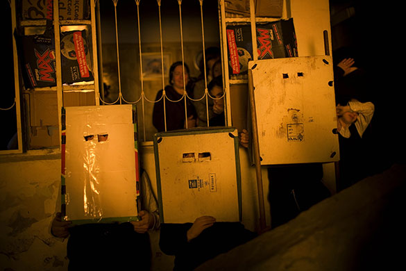 24 hours in pictures: Jerusalem: Ultra-Orthodox Jewish boys protect themselves from a bonfire