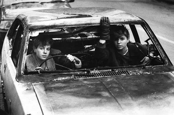 PYMCA: 1980s: Two girls in a burnt out car, Shoreditch, London