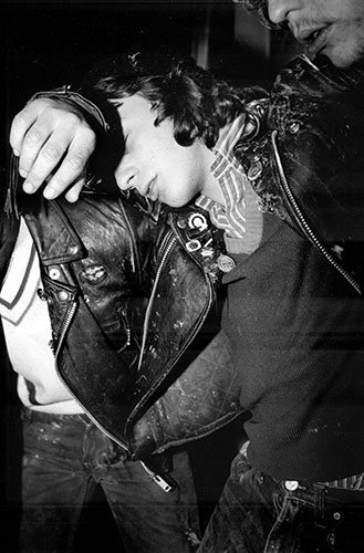 PYMCA: 1977: A drunken man being held up by his friends in the street, London