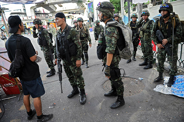 Thailand: A man talks with soldiers at dismantled anti-government protest zone