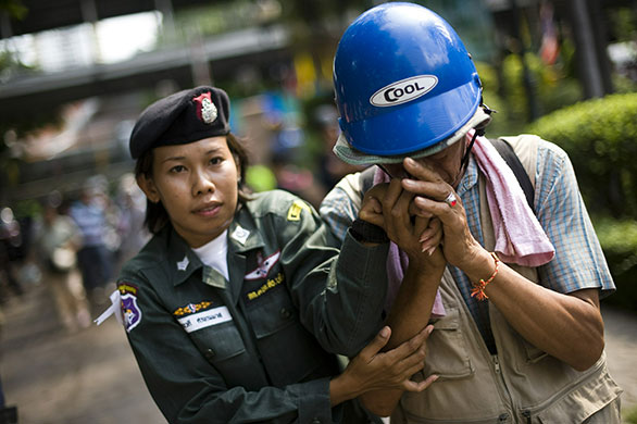 Thailand: A soldier holds the hand of a ''Red Shirt'' anti-government protester