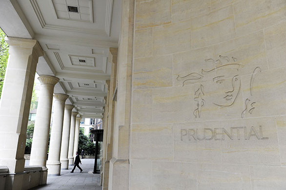 Week in business: A man leaves the Prudential offices in central London