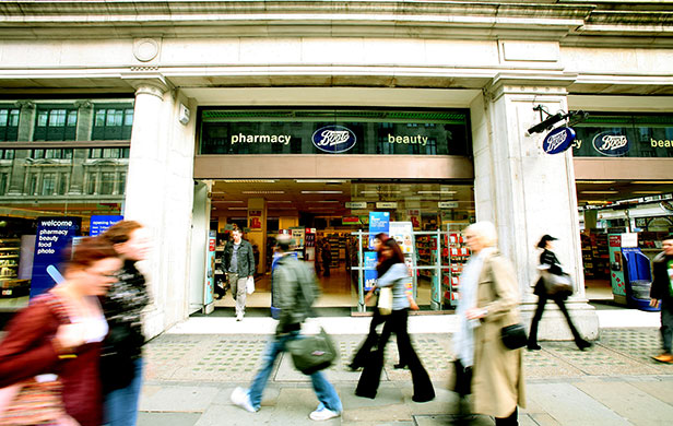 Week in business: Shoppers walk past Boots the Chemist