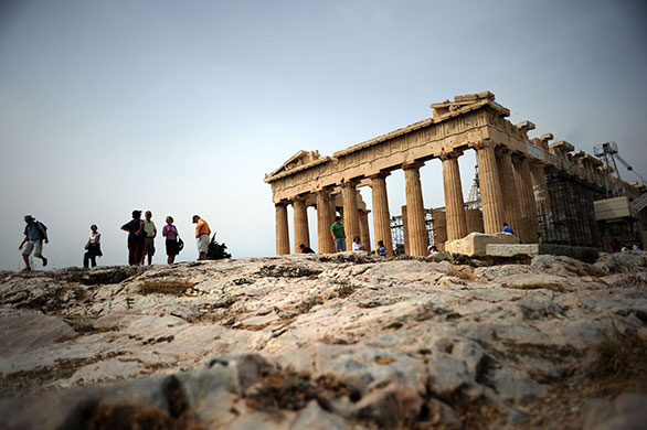24 hours in pictures: Tourists visit the Acropolis archeological site in Athens