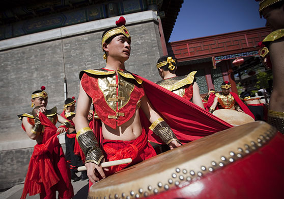 24 hours in pictures: PLA members of a waist drum band prepare to perform