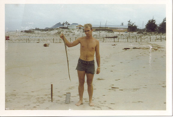 Craig Venter: Craig Venter on a beach in Vietnam with a sea snake