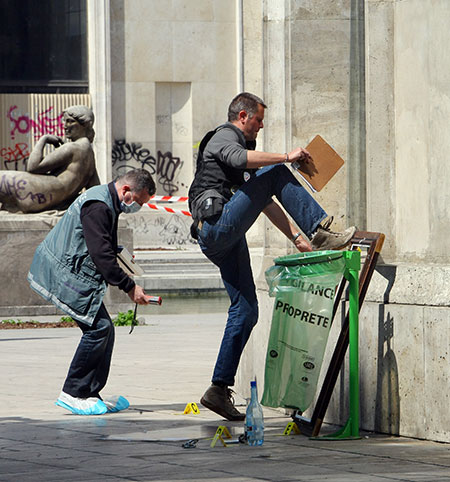 Paris art theft: A police officer climbs on the broken windows of the museum