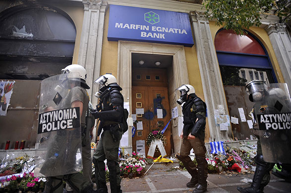 24 Hour Protest: Riot policeman at scene of the fire in 24 hour protest in Athens, Greece 