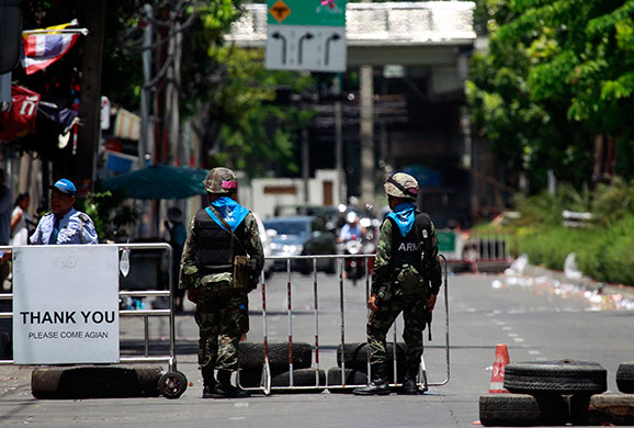 Thailand clean up: Thai soldiers stand guard by a checkpoint in central Bangkok