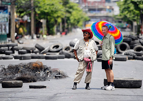 Thailand clean up: A local and a foreign man stand at a barricade