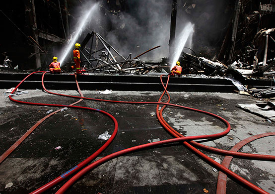 Thailand clean up: Fire-fighters douse the Central World shopping mall building in Bangkok