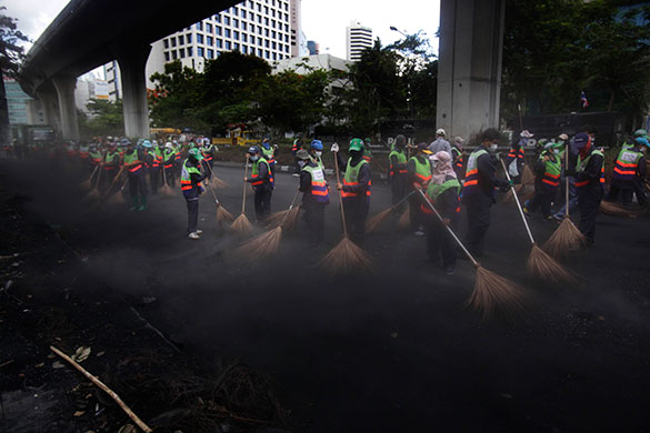 Thailand clean up: Bangkok municipal workers clean the area of Lumpini park