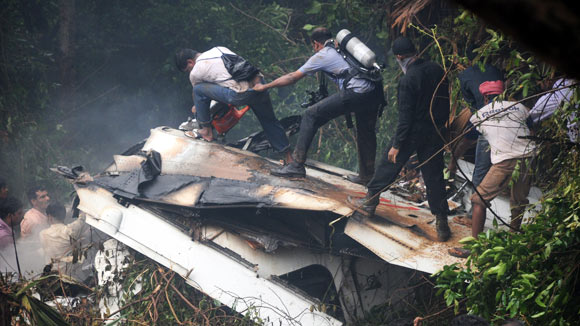 Rescuers working at the site of the Air India plane crash in Mangalore