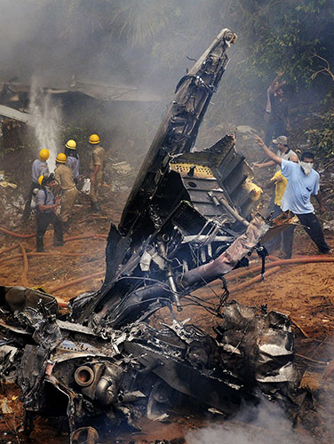 Indian Plane Crash: Indian firefighters try to extinguish the flames around the plane wreckage