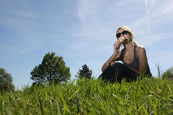 weather: A woman enjoys an ice cream on Hampstead Heath in north London