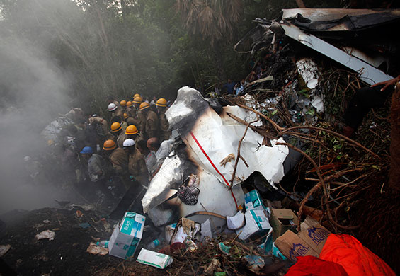 Air India plane crash: Indian firefighters look for the victims at the site of plane crash