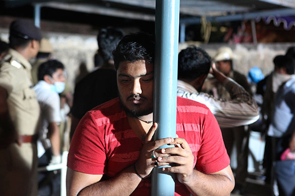 Air India plane crash: A relative of the victim waits at a mortuary in Mangalore