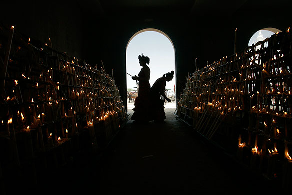 24hours:  Pilgrims light candles at the shrine of El Rocio, Spain
