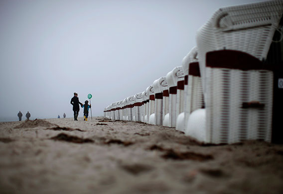 24hours: People pass a row of closed beach chairs in Rerik