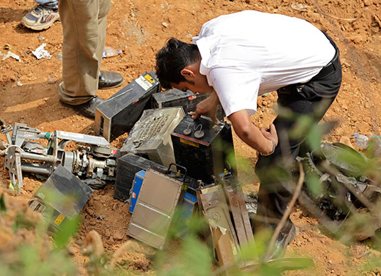 Air India crash 2: An official inspects wreckage of a crashed Air India plane