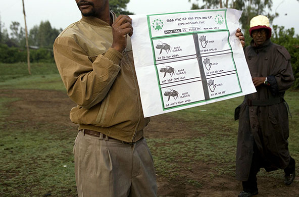 Ethiopia elections: An election worker holds up a ballot at polling station