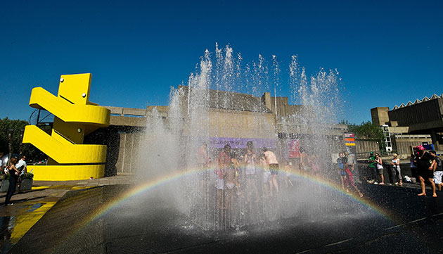 weather: A rainbow appears in the spray as children play in fountains in London