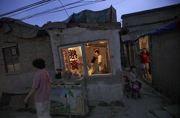 24 hours in pictures: Beijing, China: A man and his daughter work in their restaurant